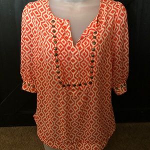 Orange and white patterned blouse